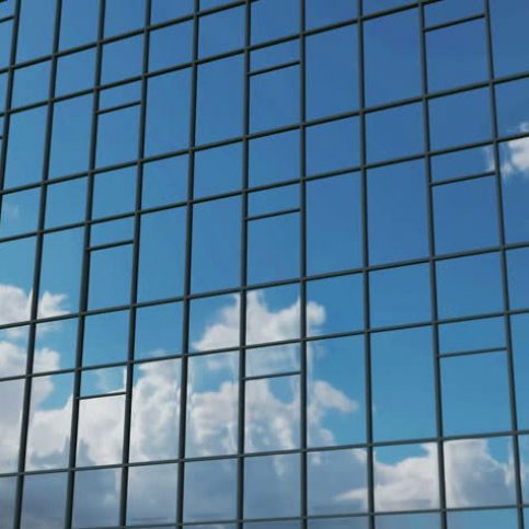 Spiegelnde Fensterfront mit Wolken im Hintergrund